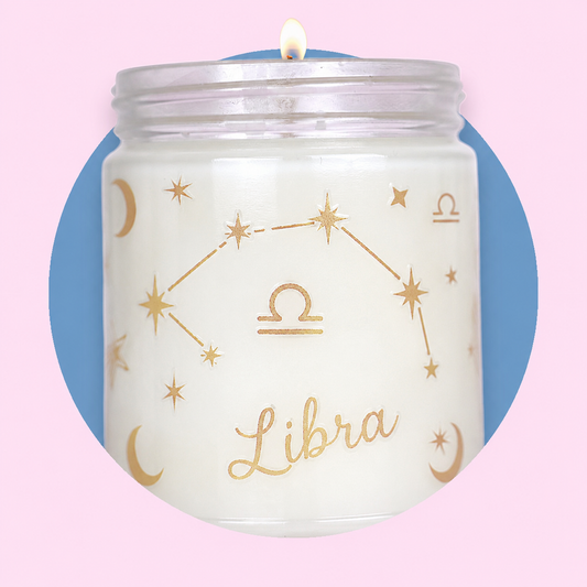 Candle in a jar with 'Libra' design on a pink and blue gradient background